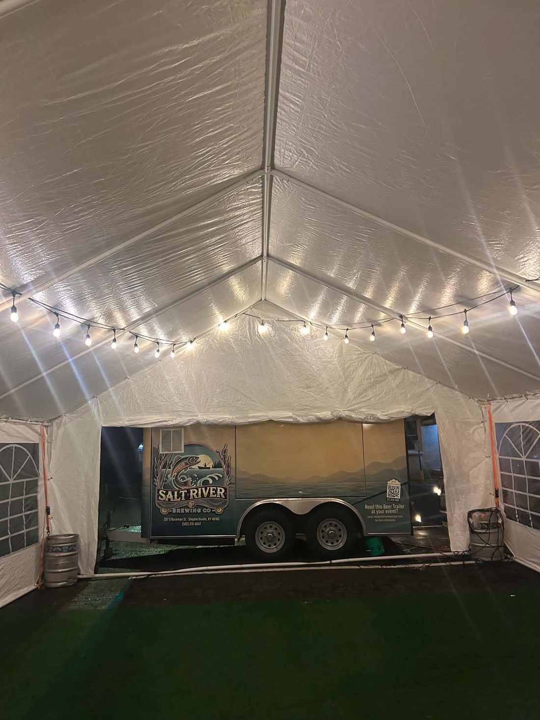 The Salt River beer trailer at the end of a tent with string lights